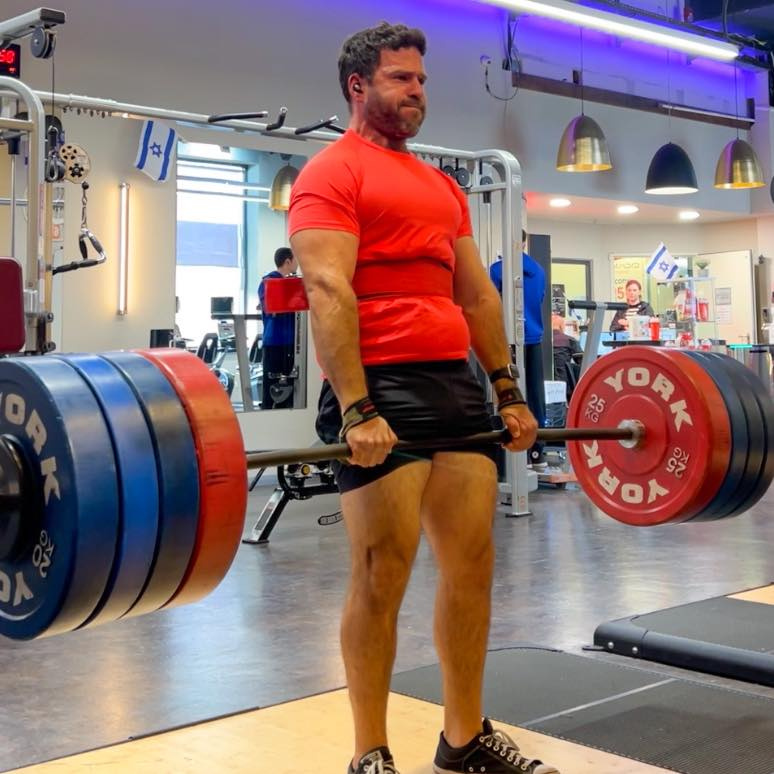 Adam Grossman finishing a deadlift on the lifting platform